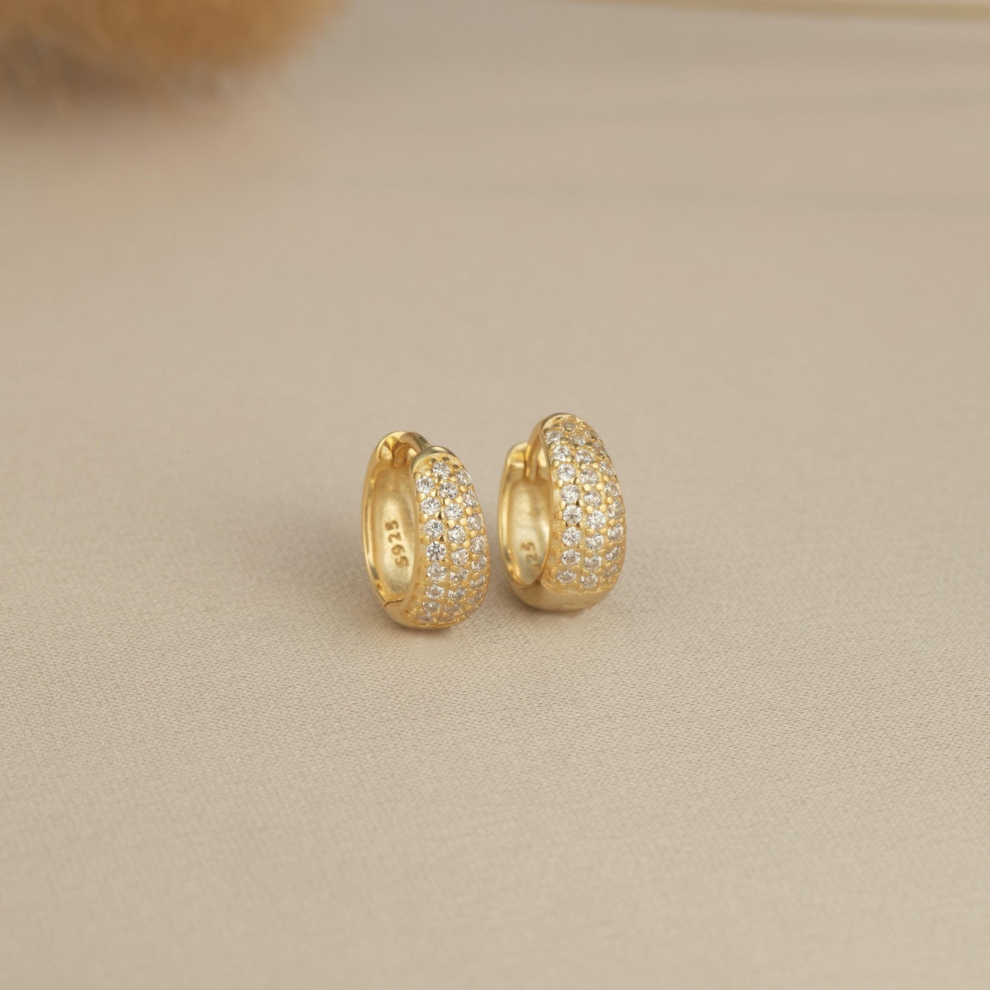 a pair of yellow gold and diamond earrings
