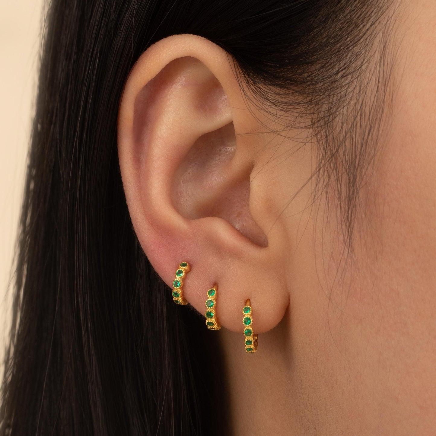 a close up of a person wearing a pair of earrings