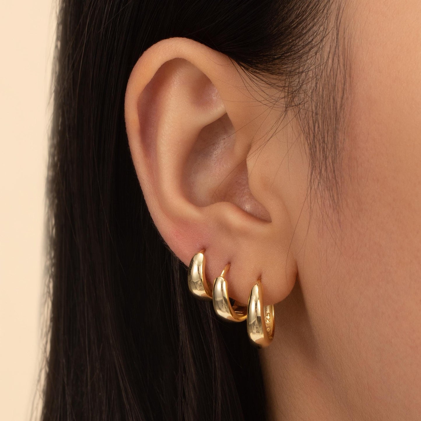 a close up of a person wearing a pair of earrings