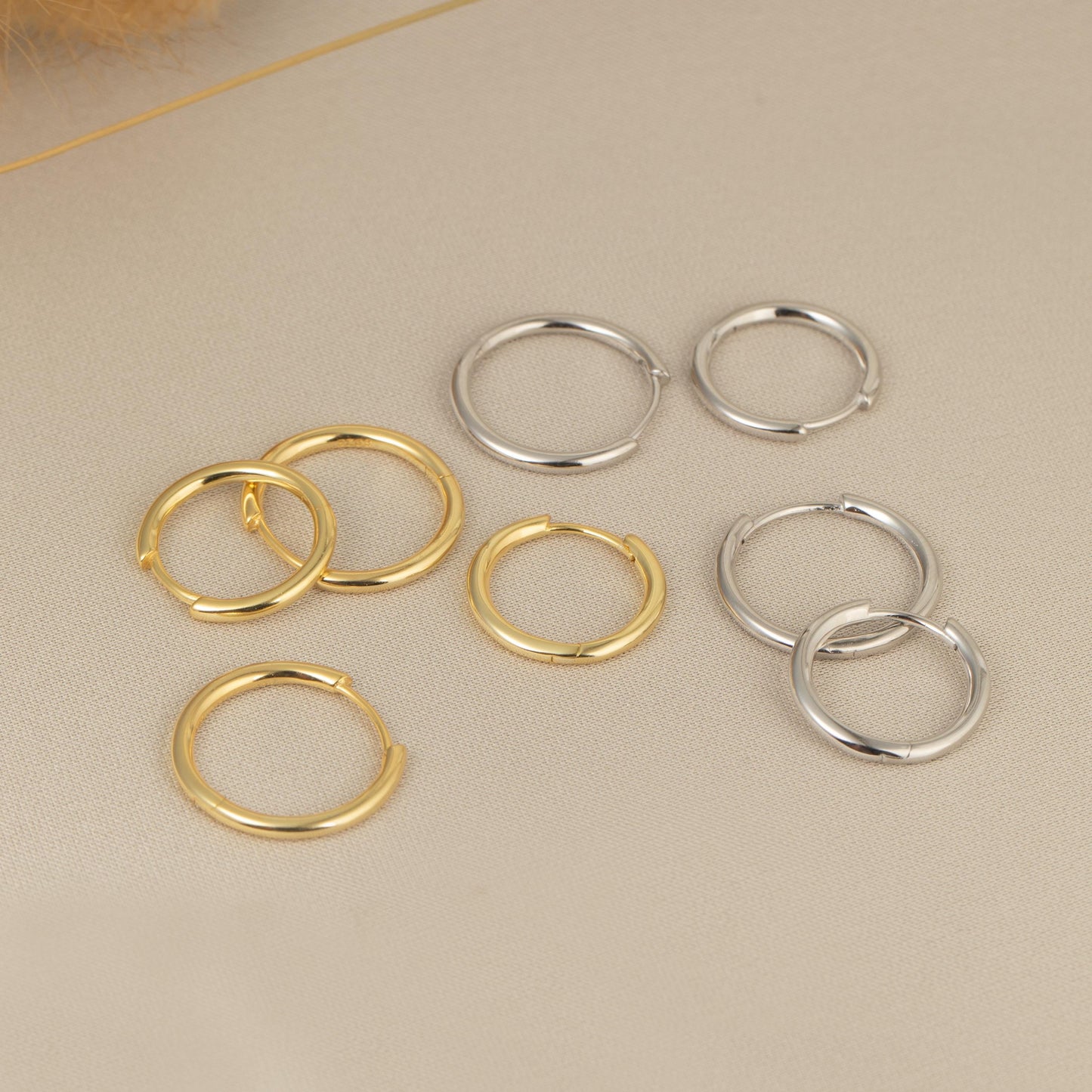 five pairs of gold and silver rings on a table