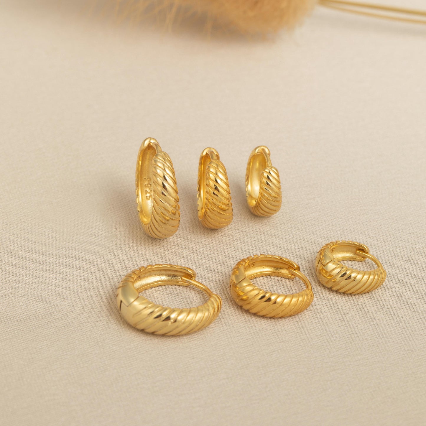 a bunch of gold rings sitting on top of a table