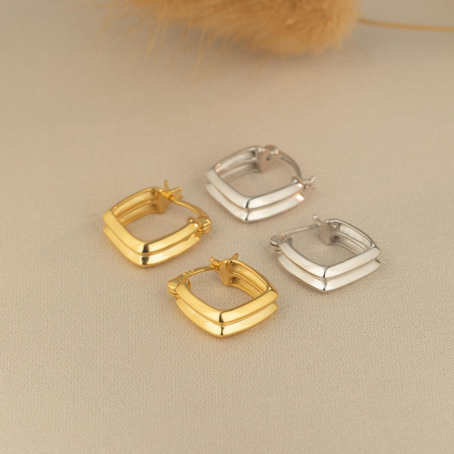 three pairs of small gold and silver earrings