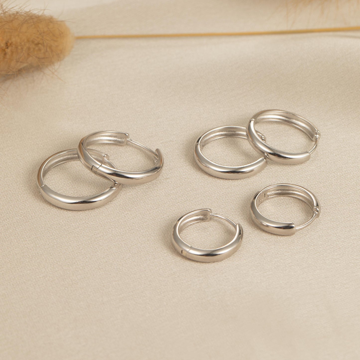 a group of silver rings sitting on top of a table