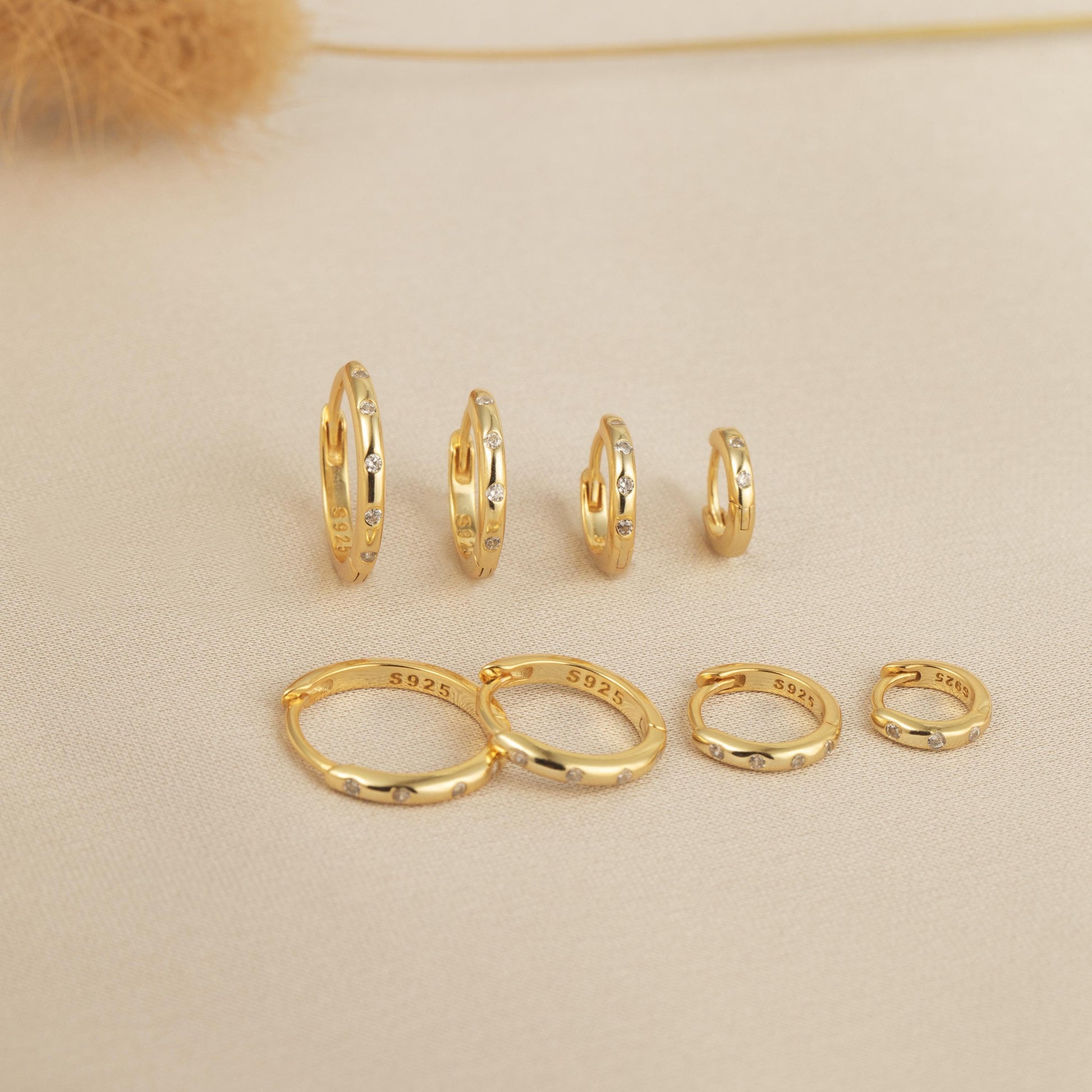 a group of gold rings and a pair of earrings