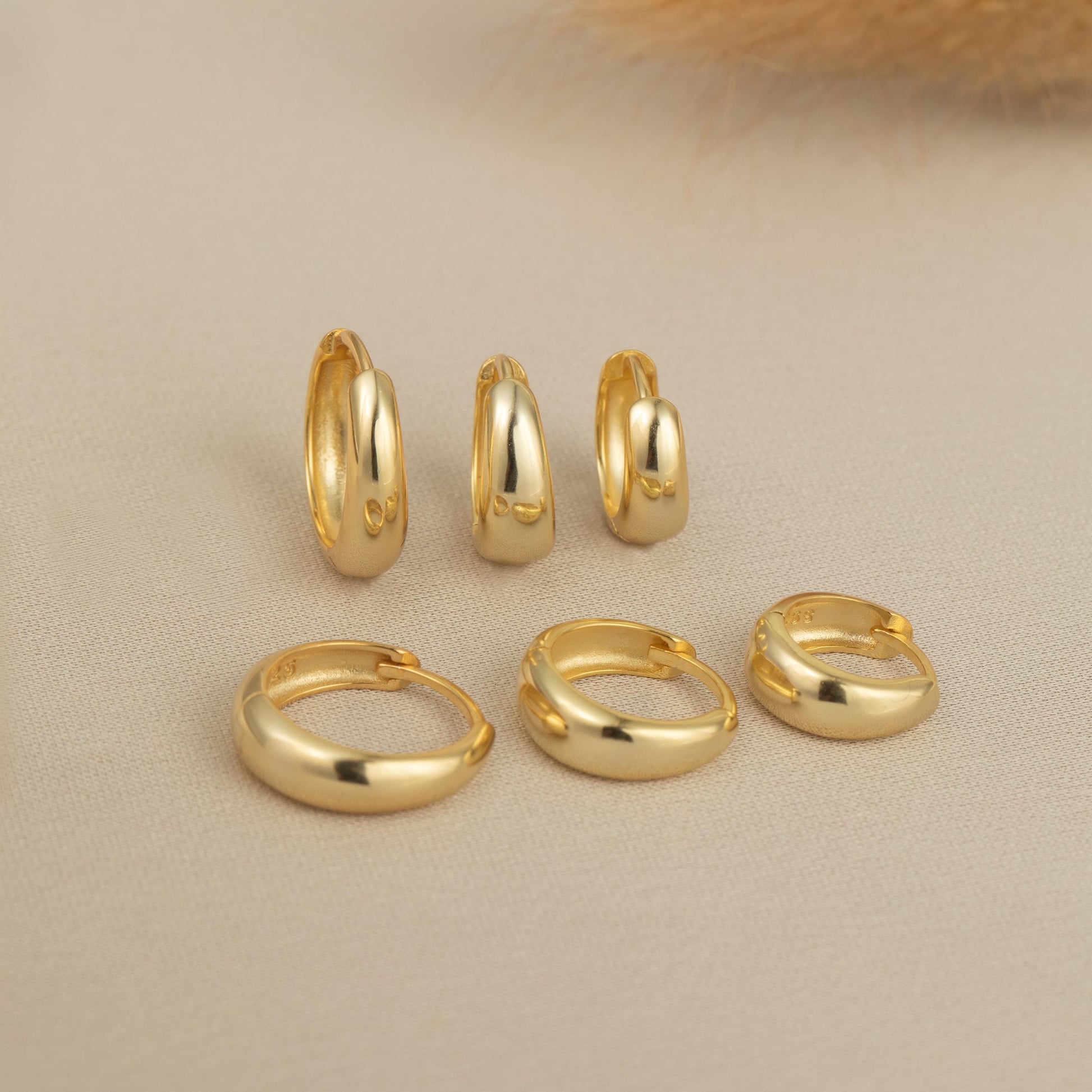 a group of gold rings on a white surface