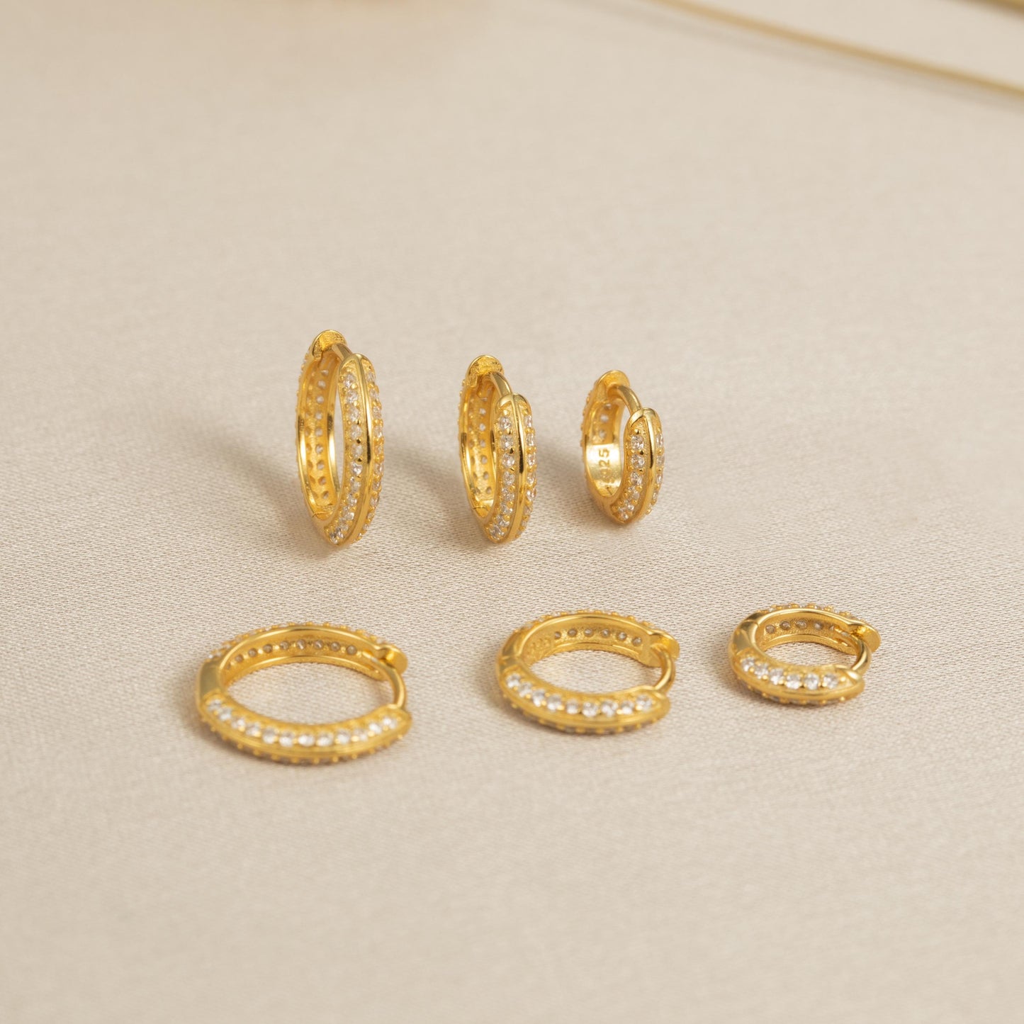 a group of gold rings and a pair of earrings