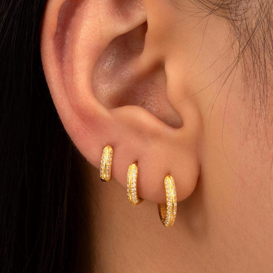 a close up of a person wearing a pair of earrings