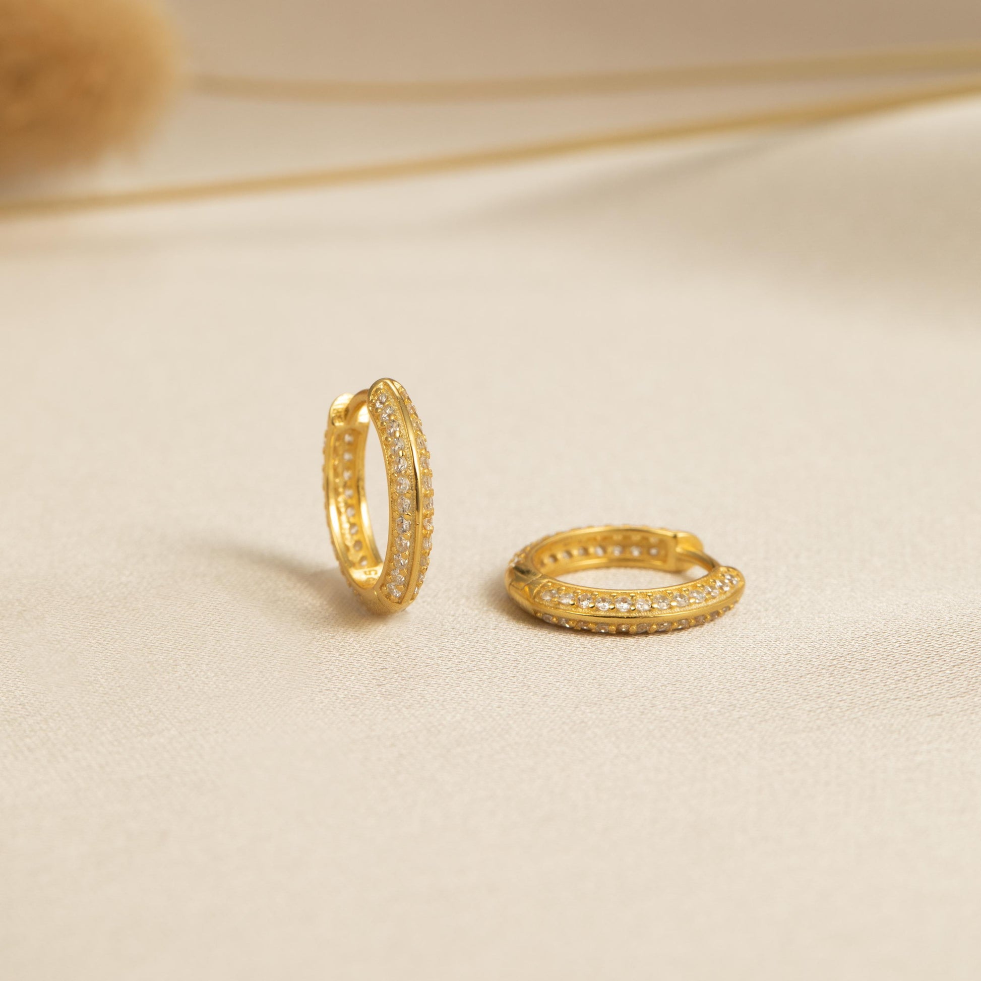 a couple of gold rings sitting on top of a table
