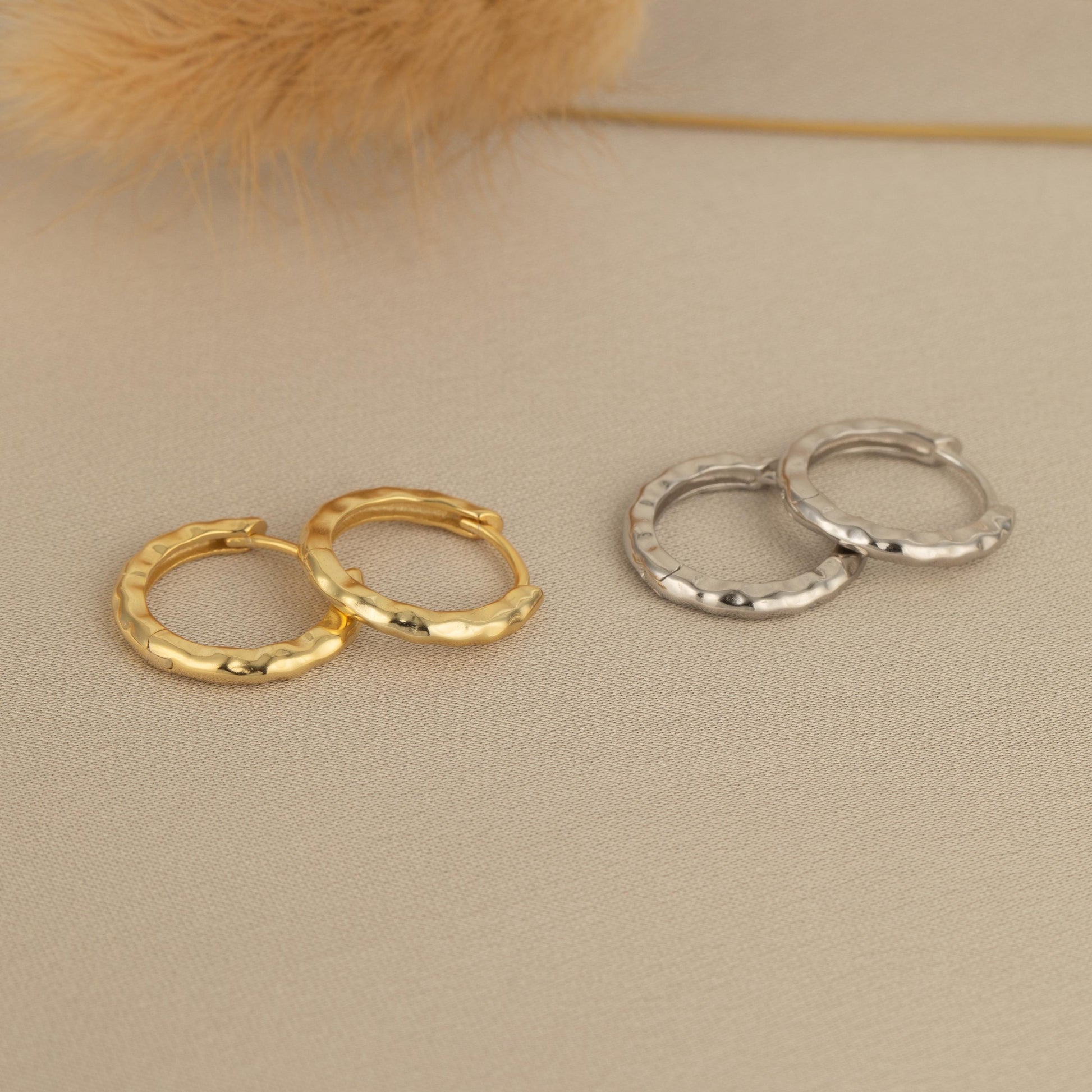 three pairs of small gold and silver hoop earrings
