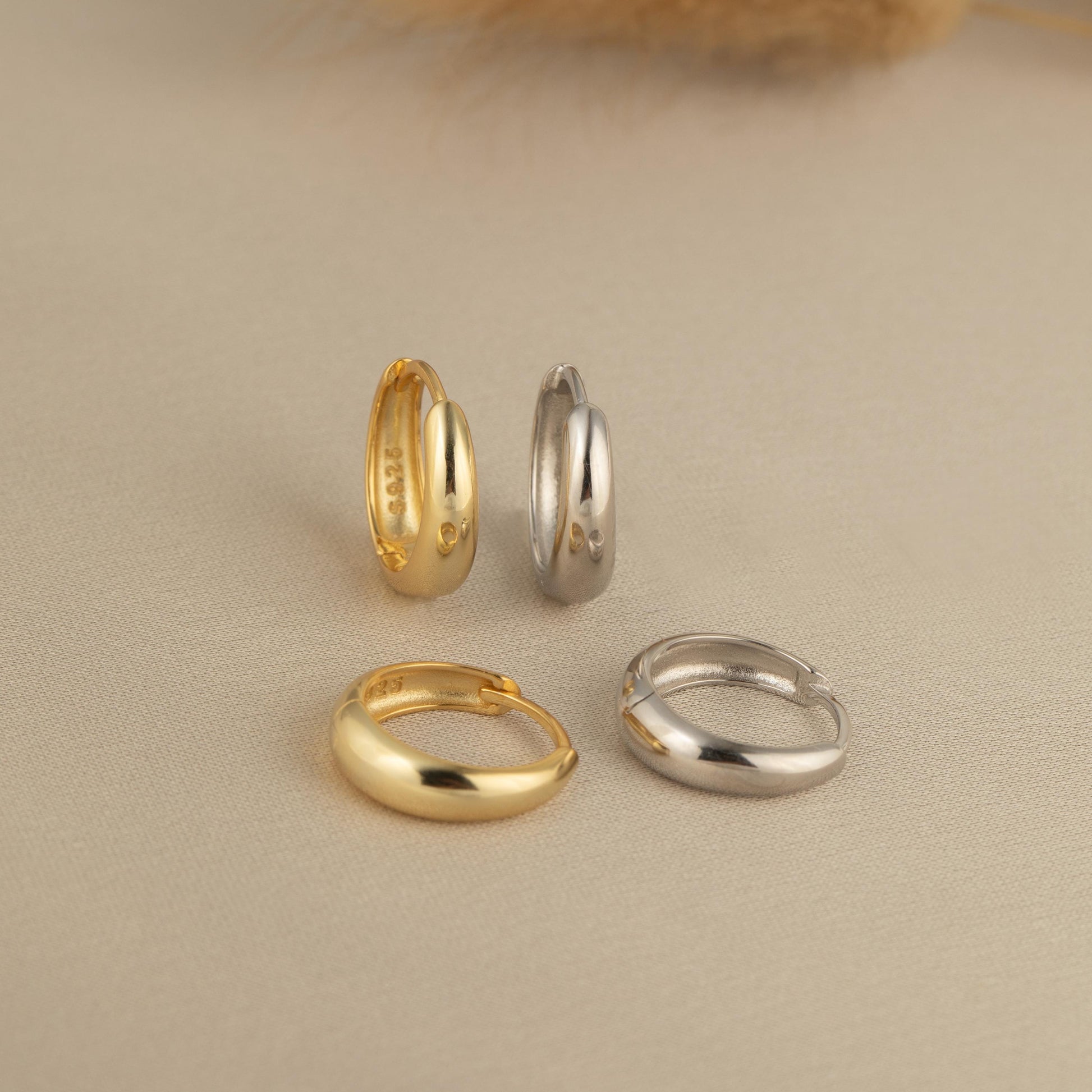 a group of three different colored gold and silver rings