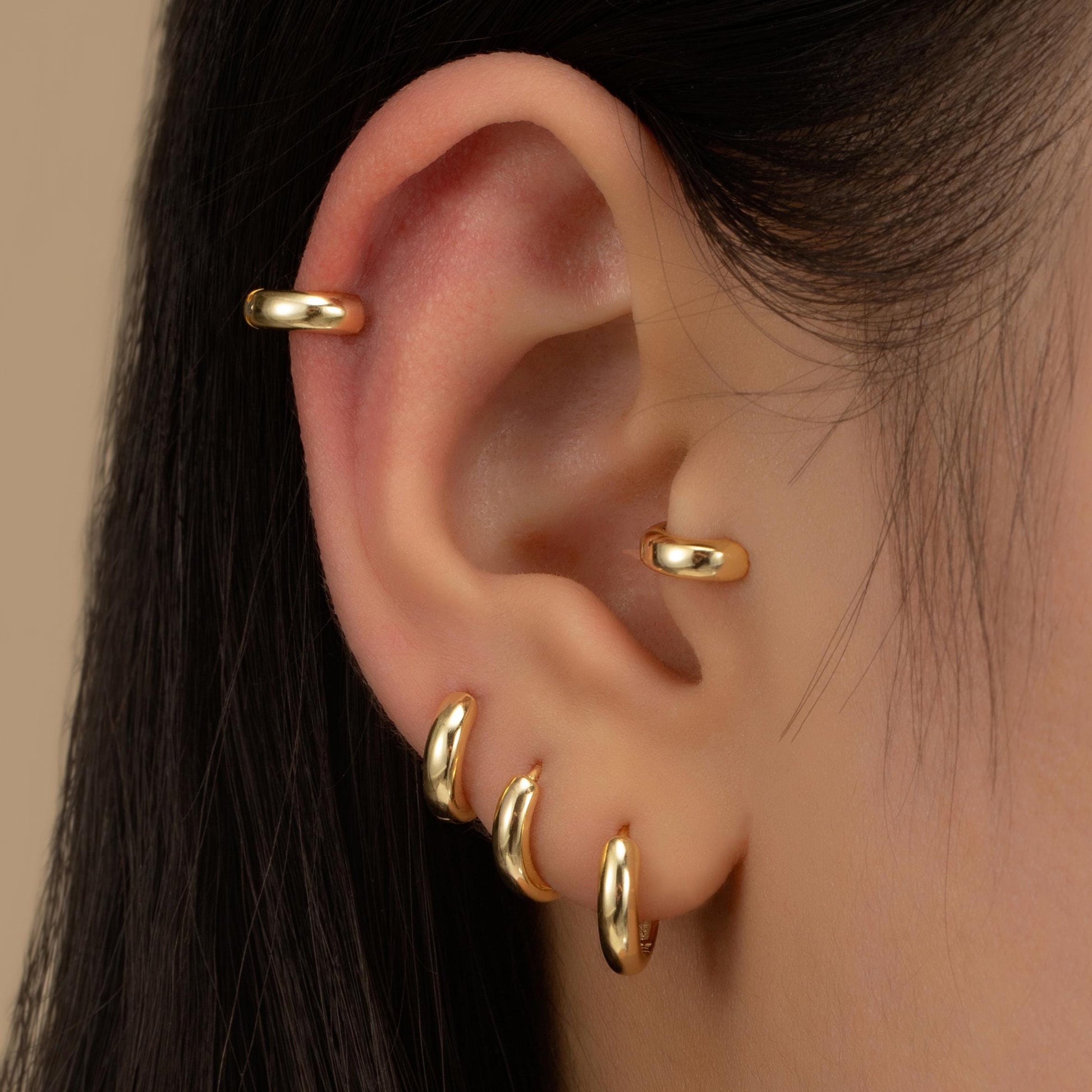 a close up of a person wearing a pair of ear piercings