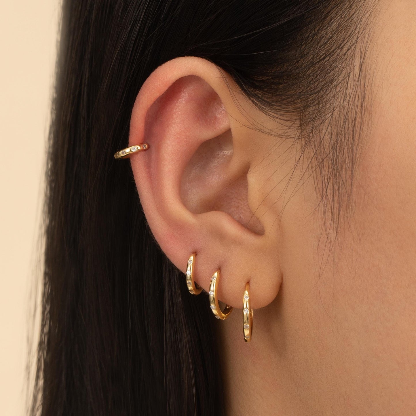 a close up of a person wearing a pair of earrings