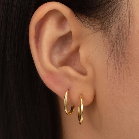 a close up of a person wearing a pair of earrings
