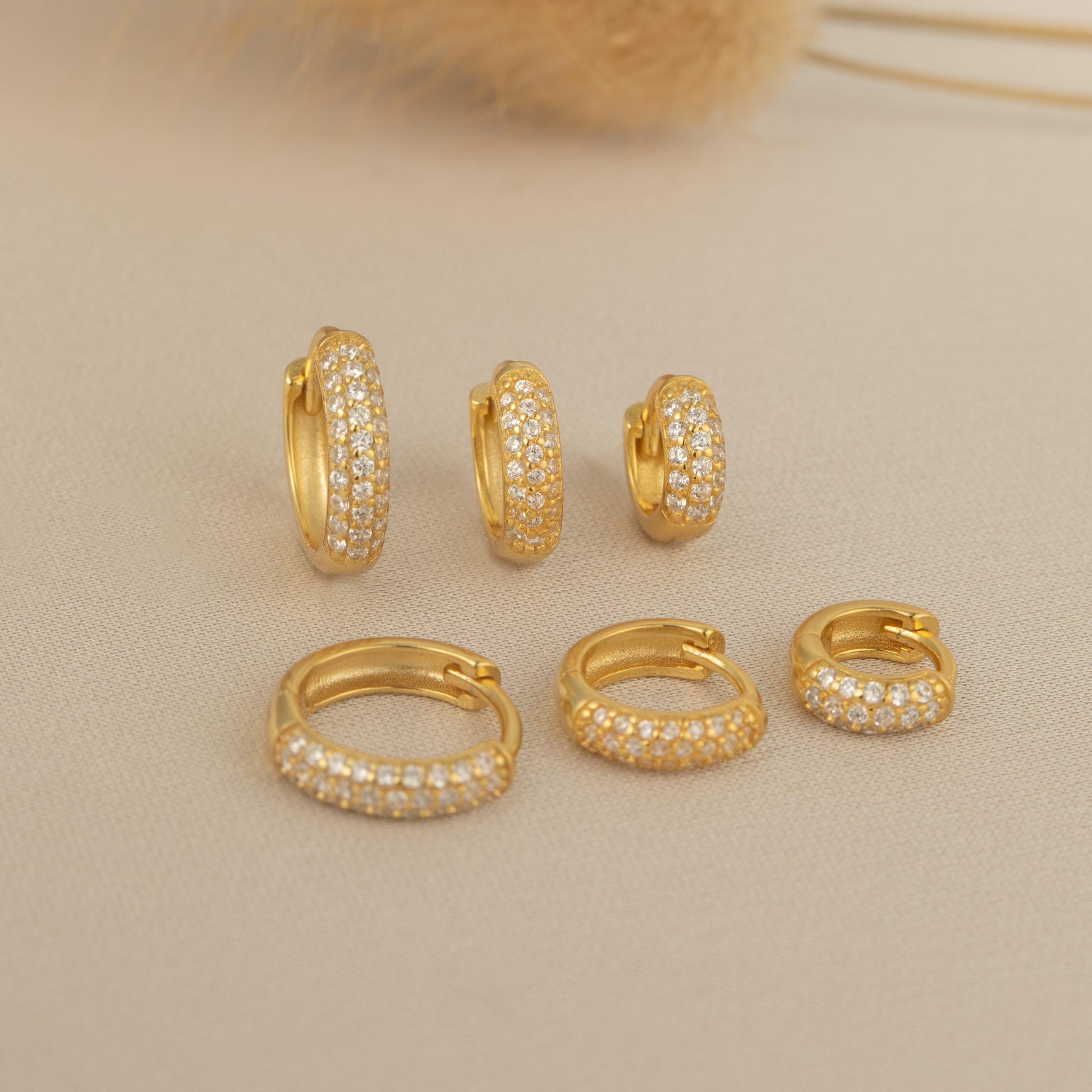 a set of four gold - plated earrings and a pair of earrings