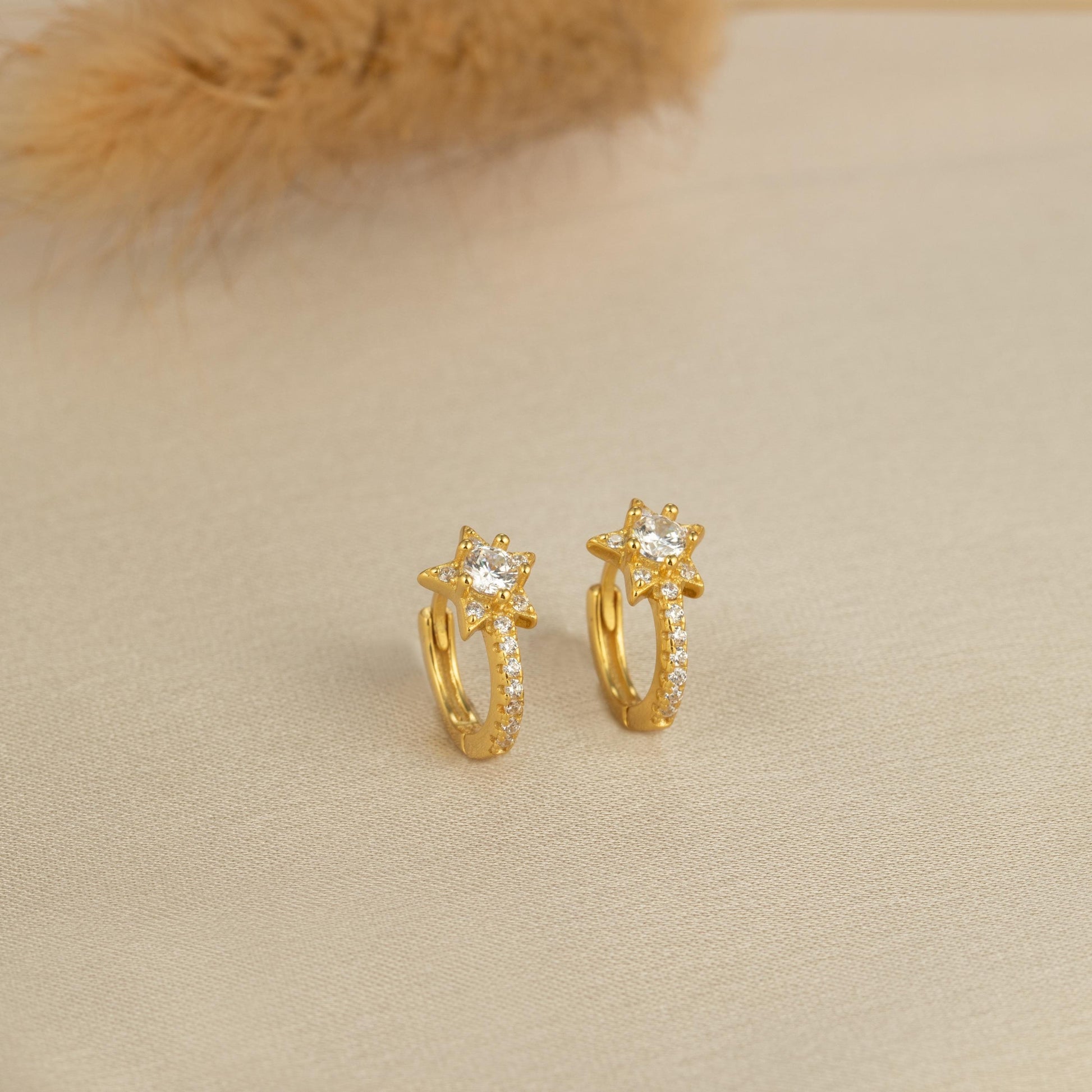 a pair of yellow gold earrings with diamonds