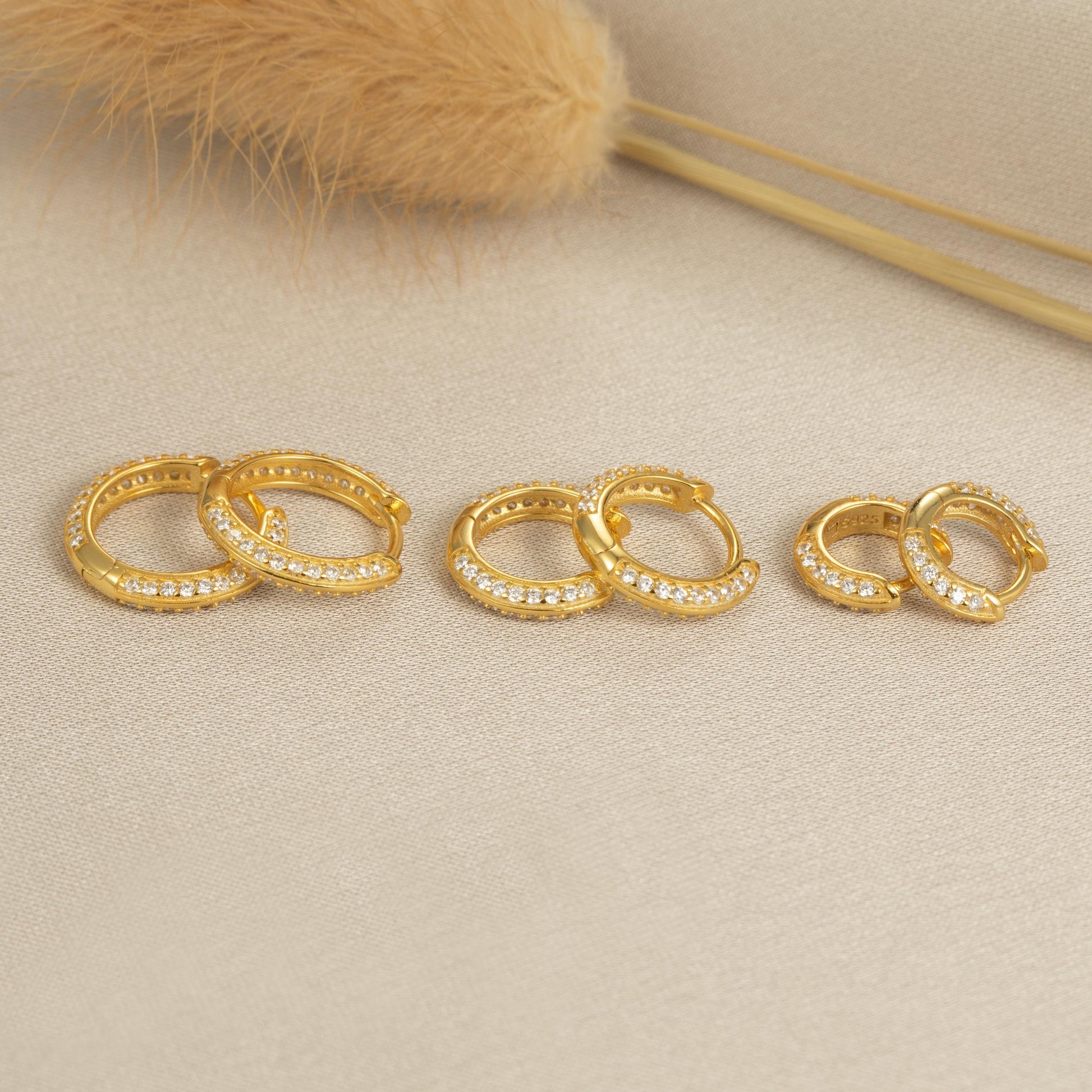 a set of three gold rings sitting on top of a table