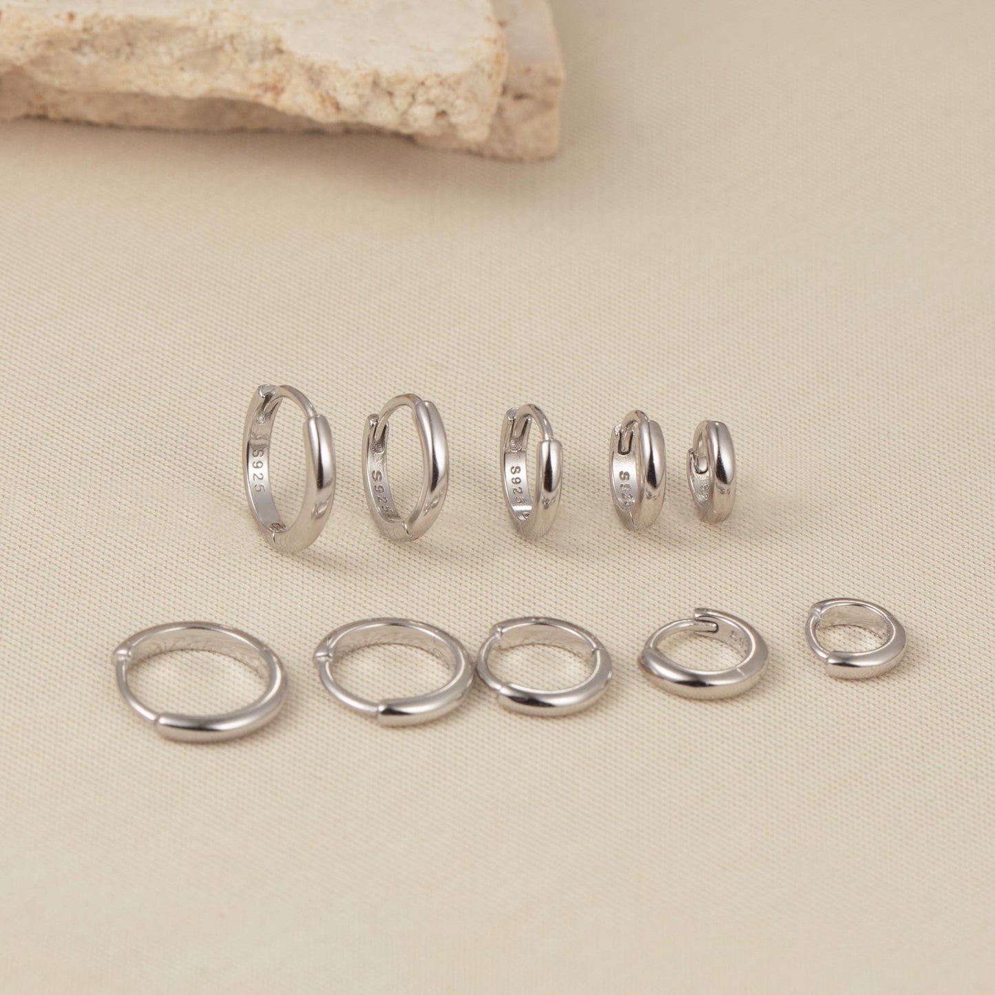 a group of rings and a rock on a table