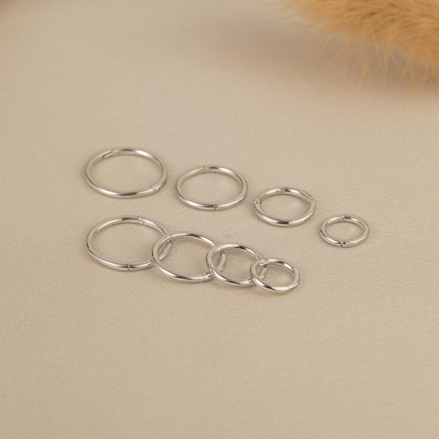 a group of silver rings sitting on top of a table