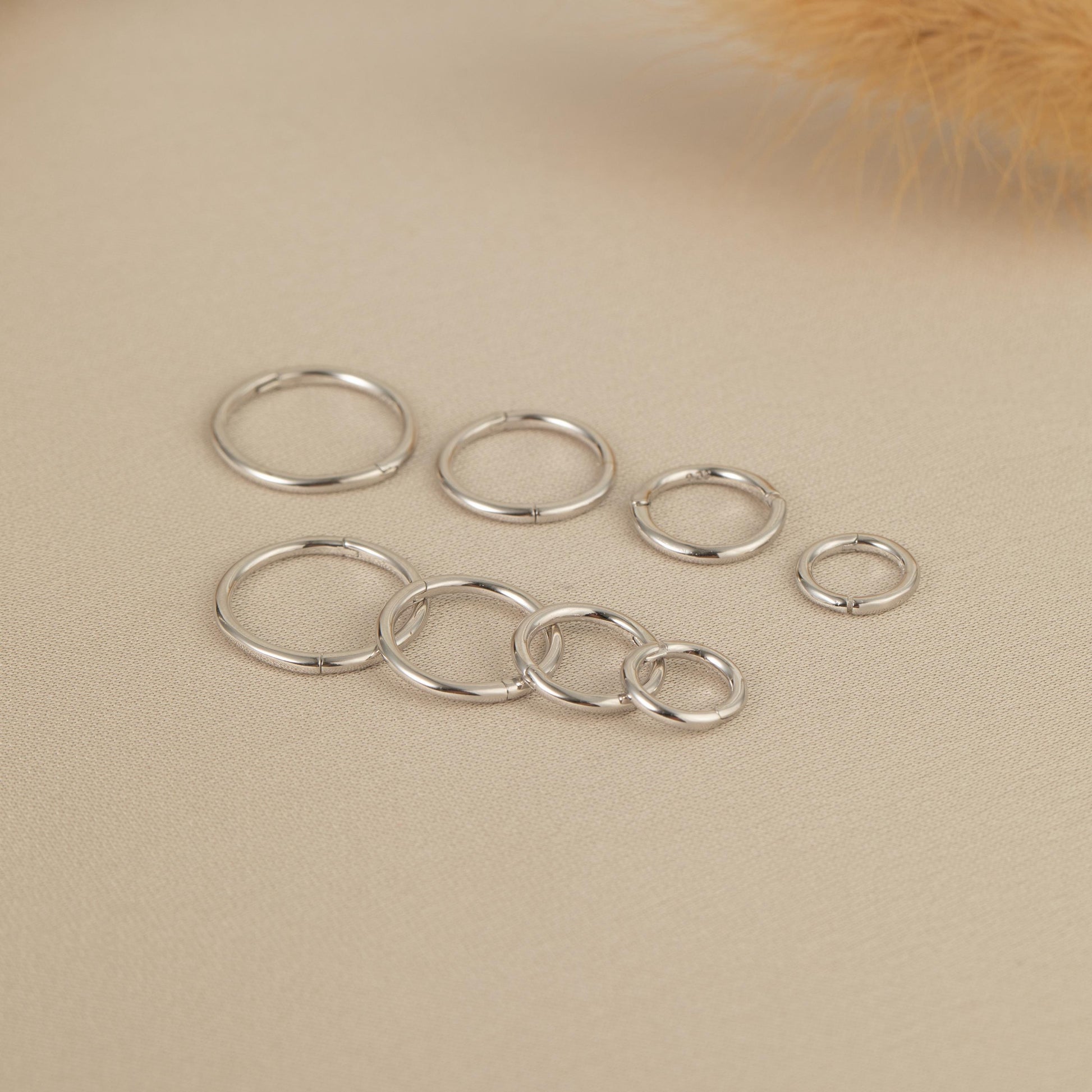 a group of silver rings sitting on top of a table