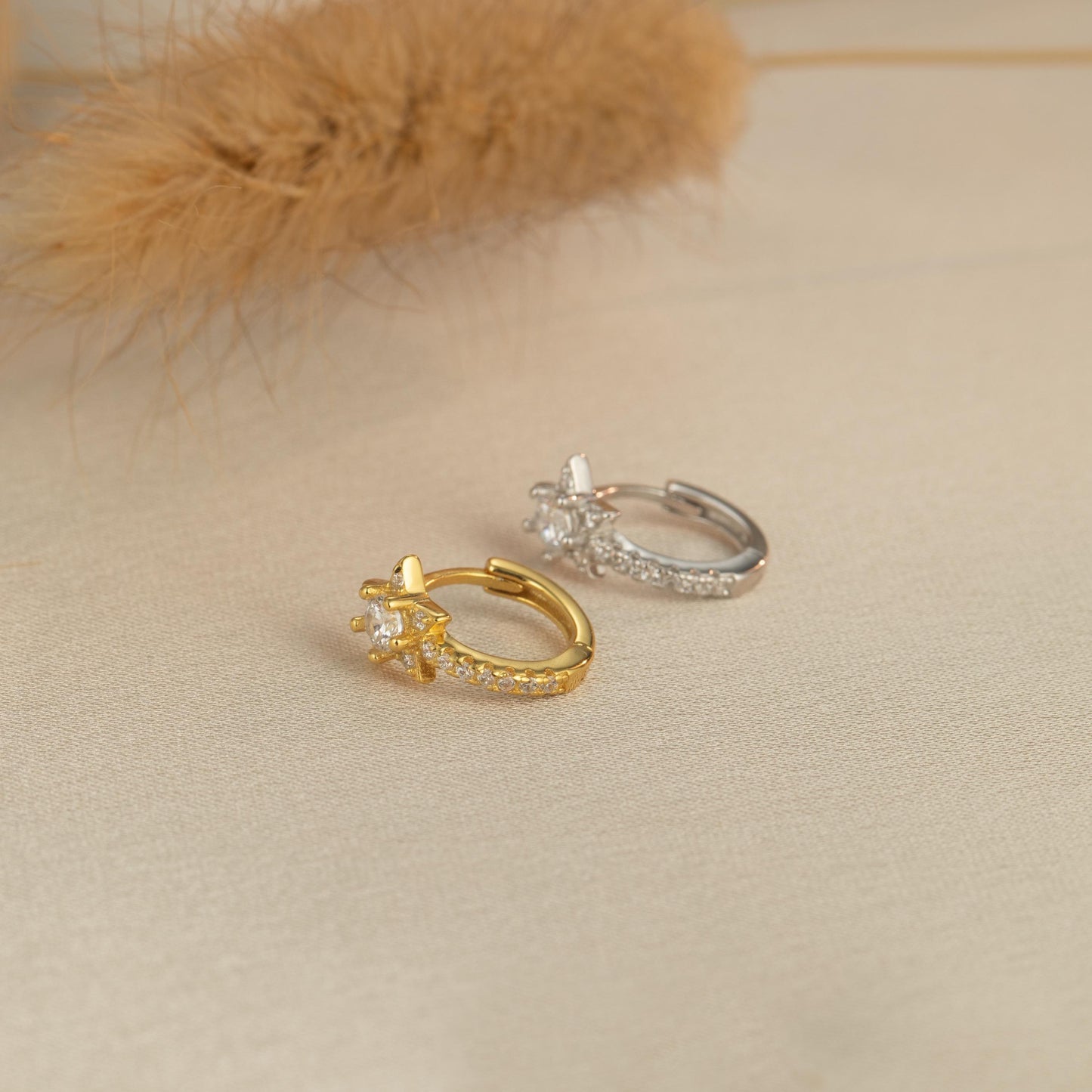two gold and silver rings on a white surface