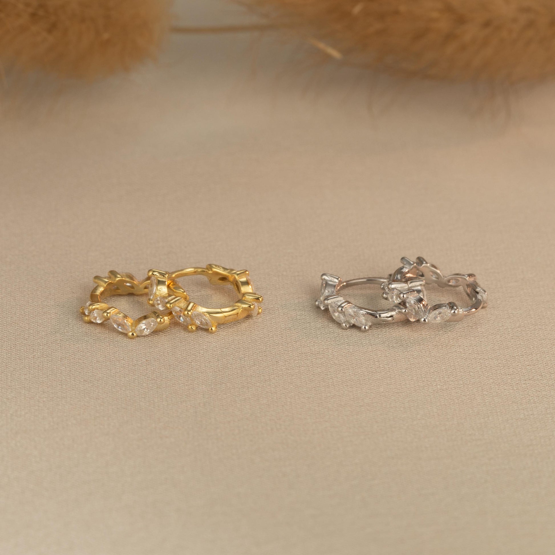 a pair of gold and silver rings sitting on top of a table