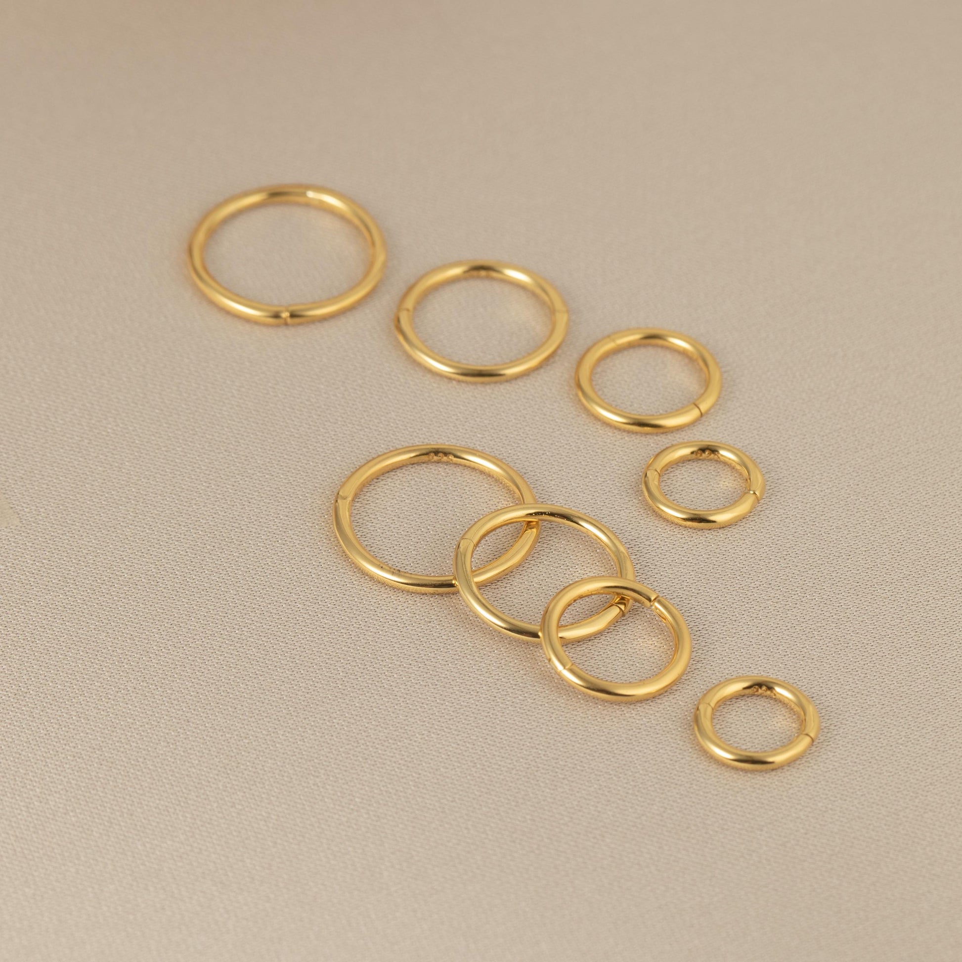 a group of gold rings sitting on top of a table