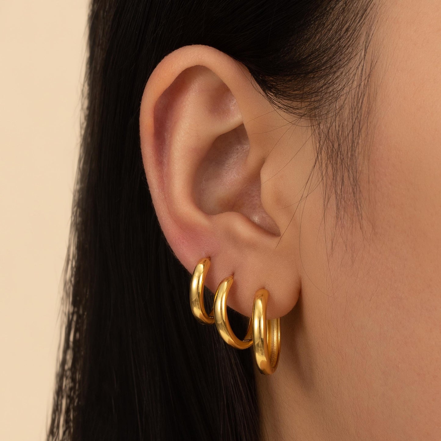 a close up of a person wearing a pair of earrings