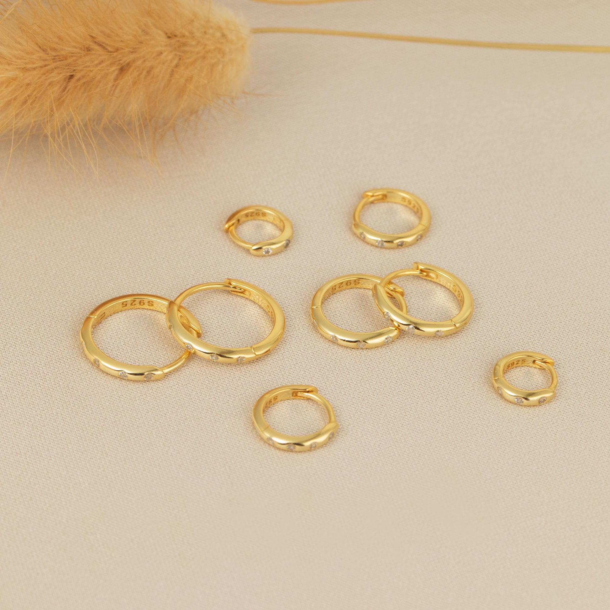 a bunch of gold rings sitting on top of a table