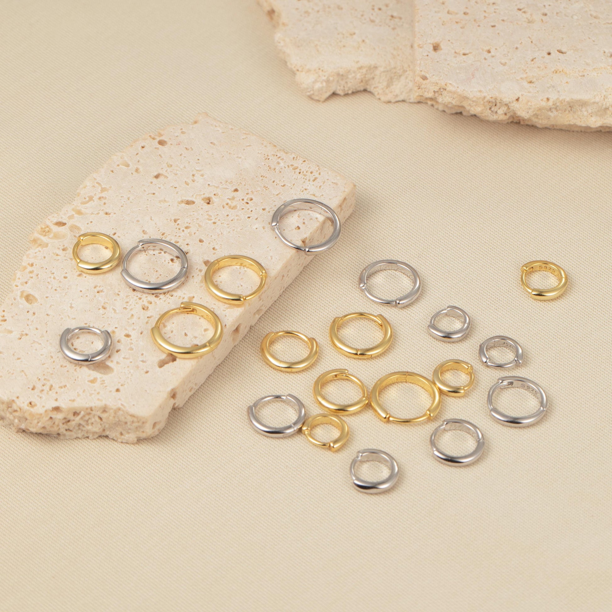 a bunch of rings sitting next to a rock
