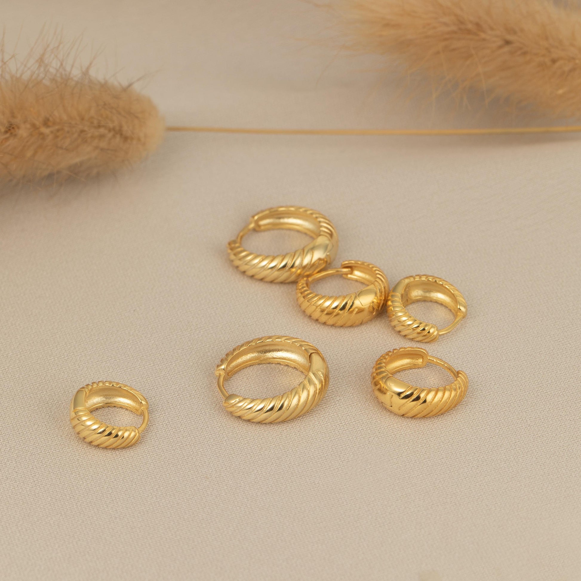 a group of gold rings sitting on top of a table