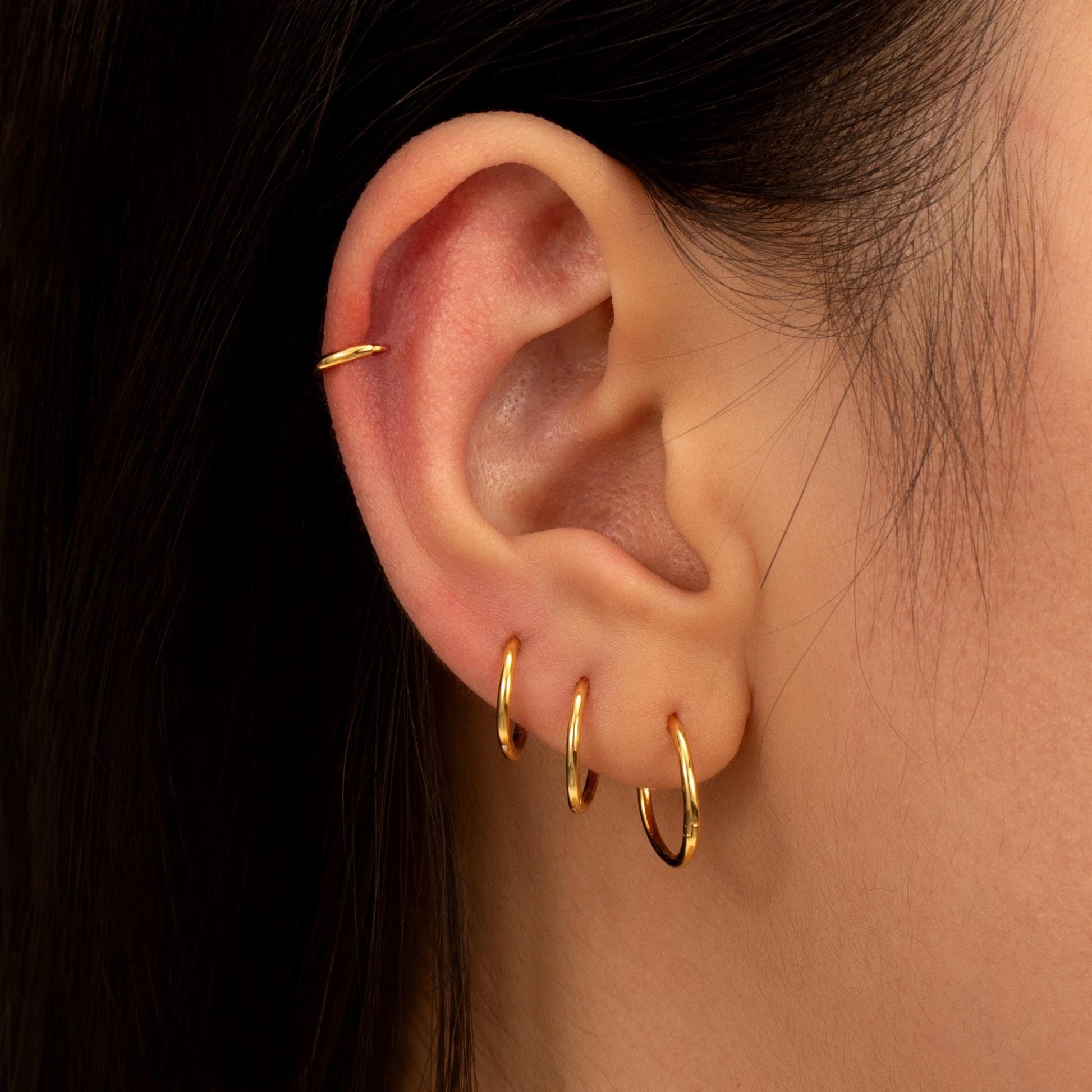 a close up of a person wearing a pair of earrings