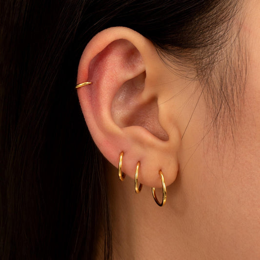 a close up of a person wearing a pair of earrings