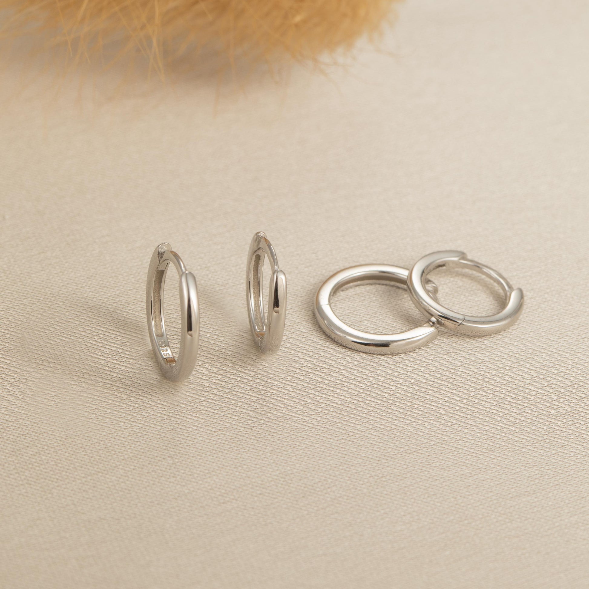 a couple of silver rings sitting on top of a table