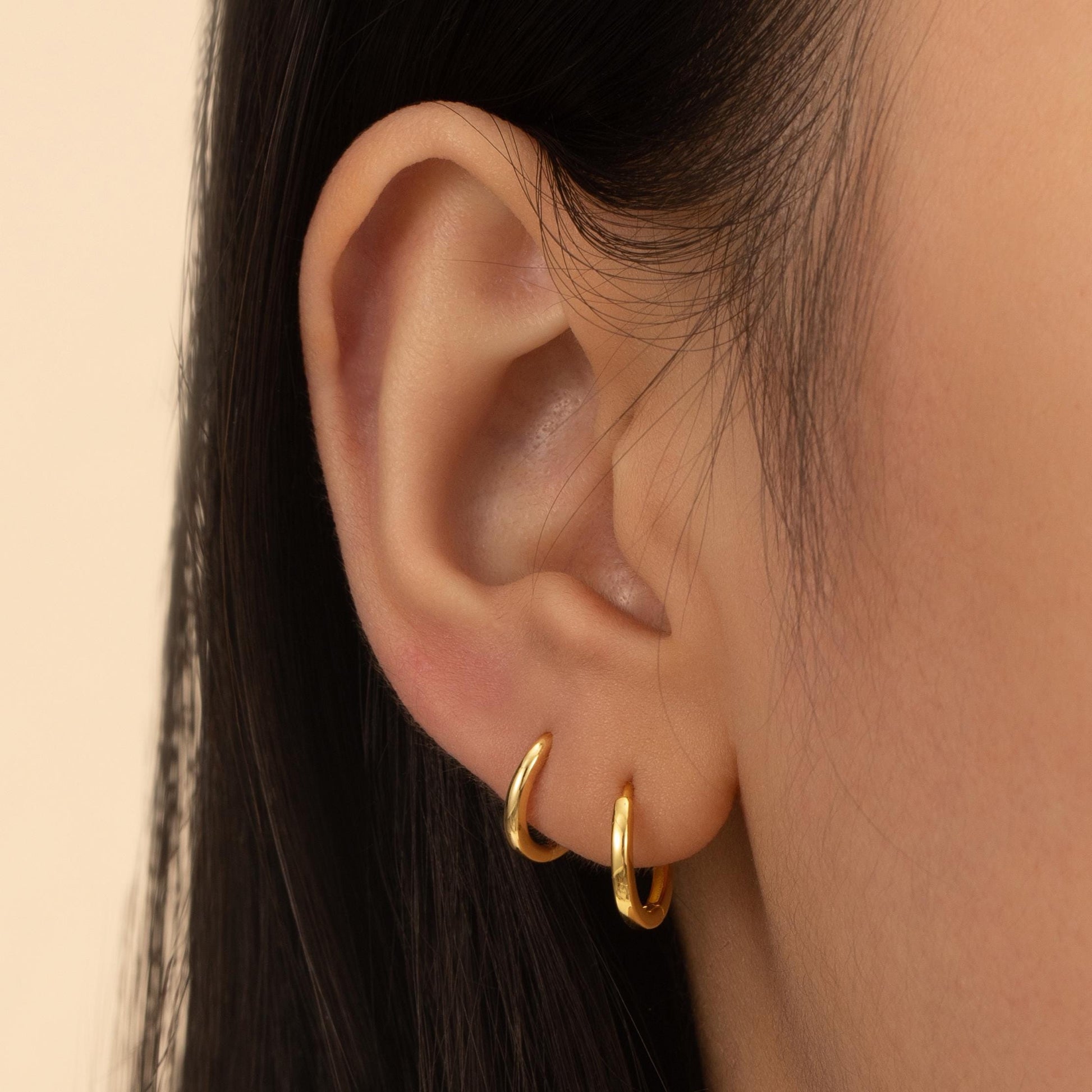 a close up of a person wearing a pair of earrings