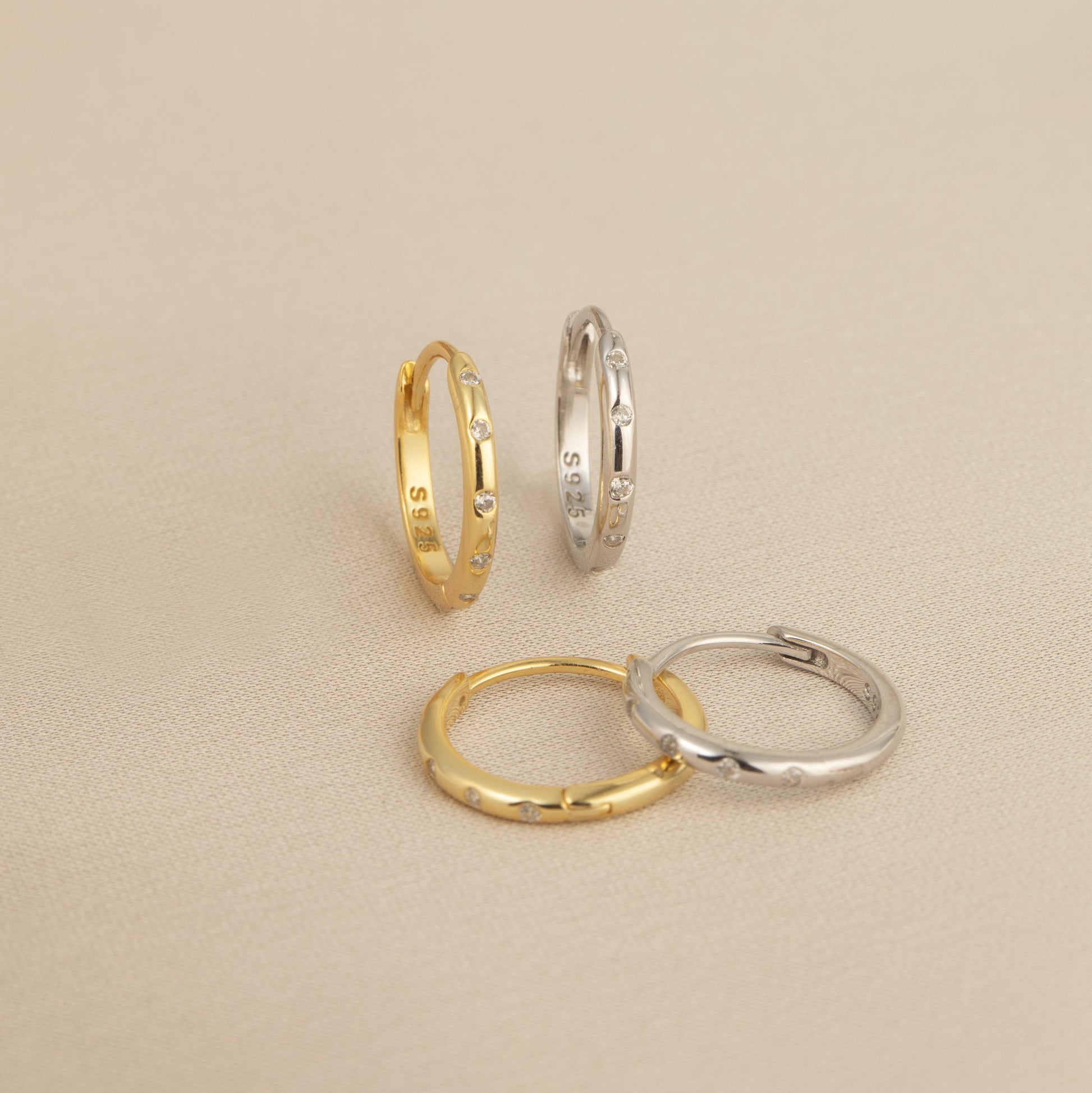 three different types of wedding rings on a plain surface
