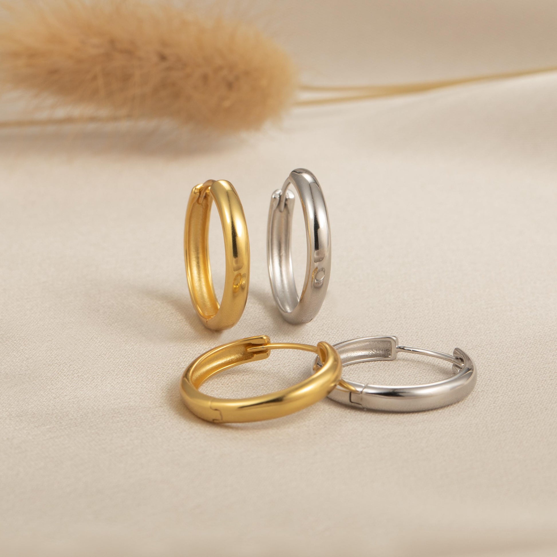 three different types of rings sitting on a bed