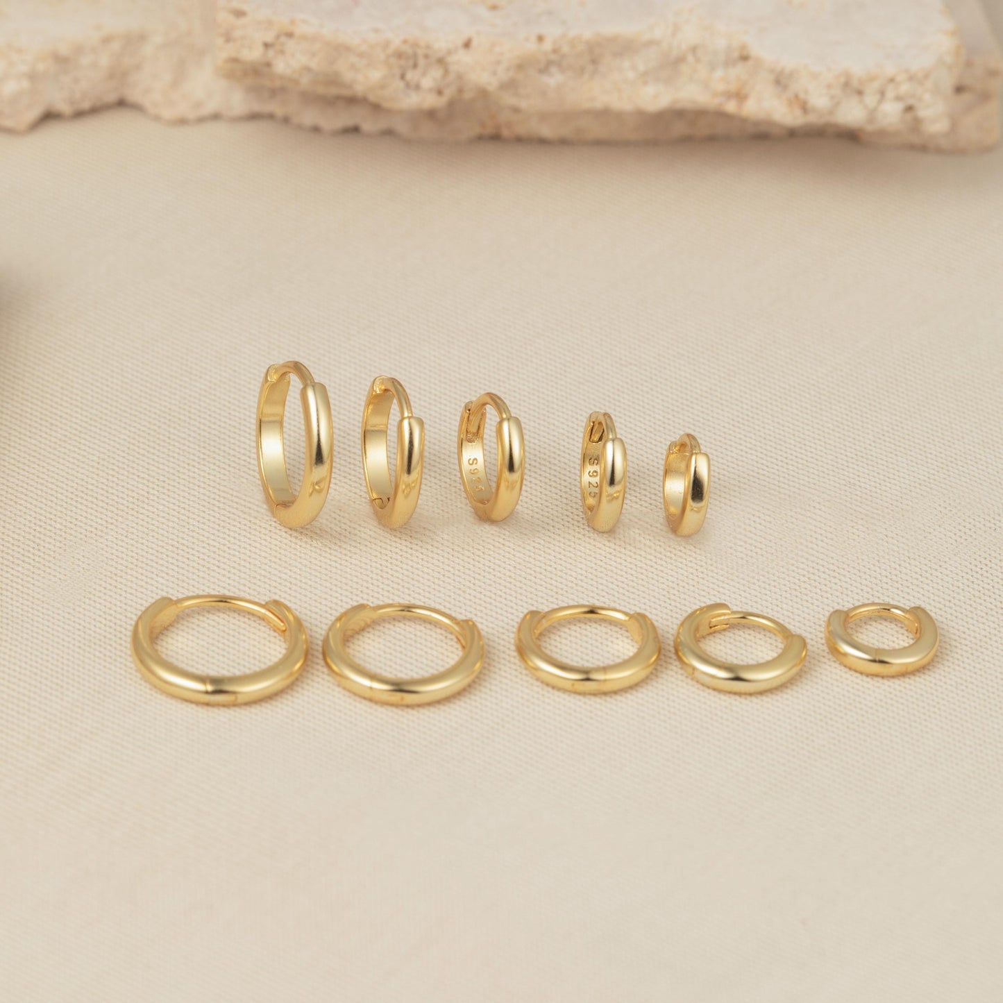 a group of gold rings sitting on top of a table