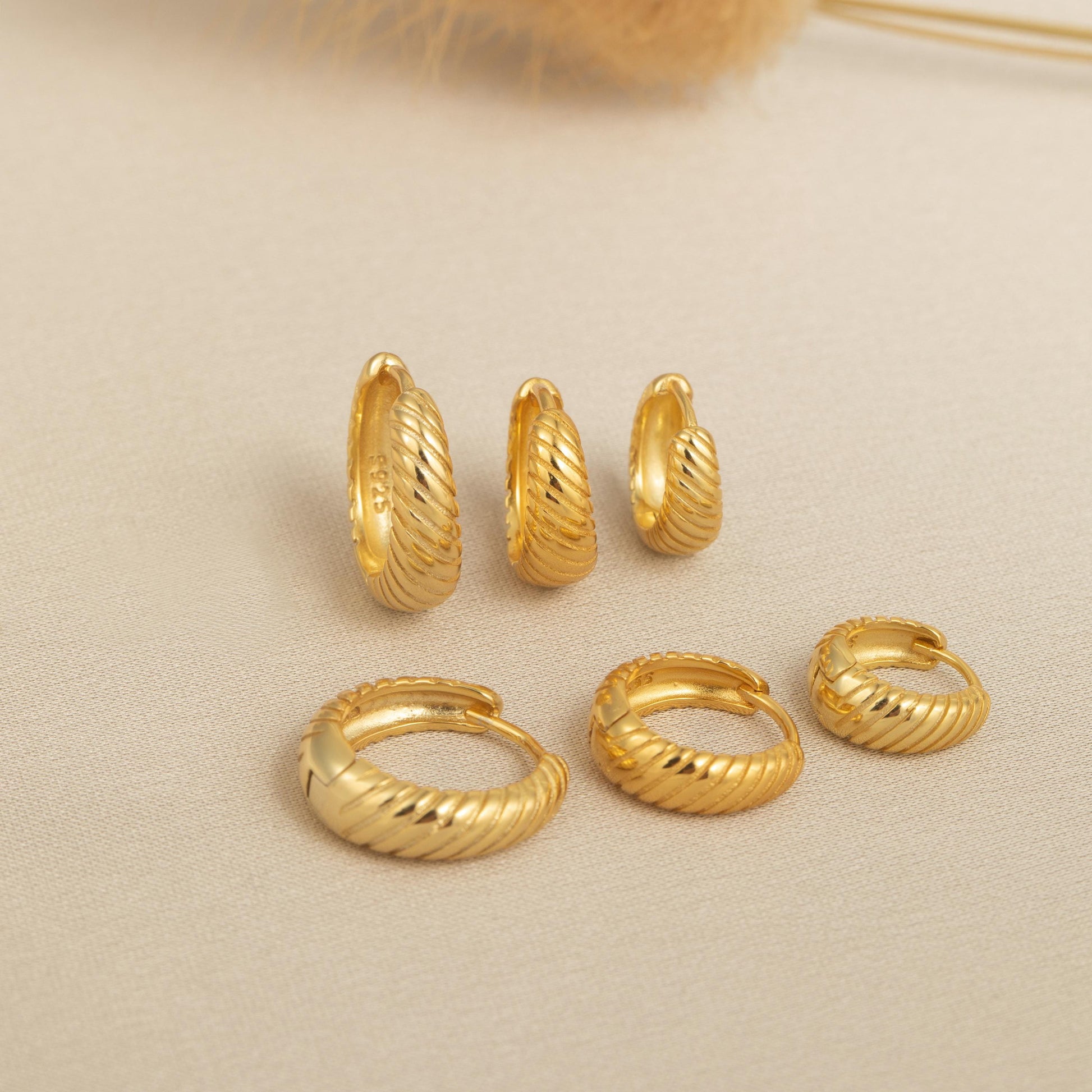 a bunch of gold rings sitting on top of a table