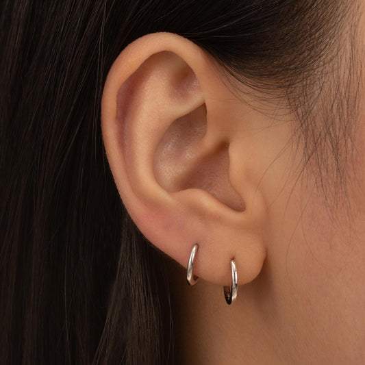 a close up of a person wearing a pair of earrings