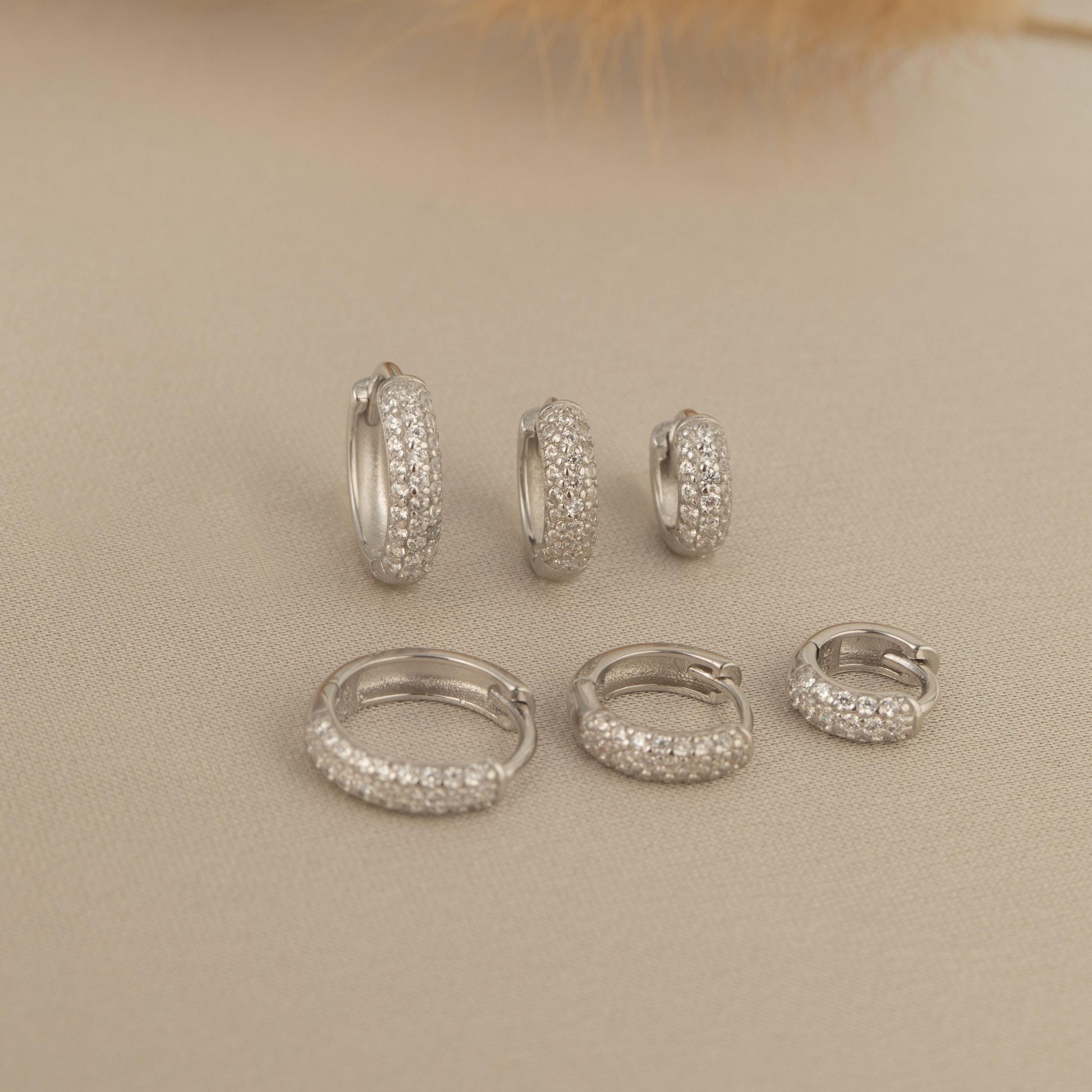 a set of five pairs of diamond hoop earrings