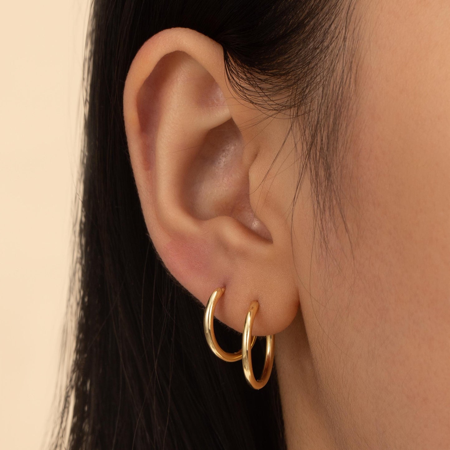 a close up of a person wearing a pair of earrings