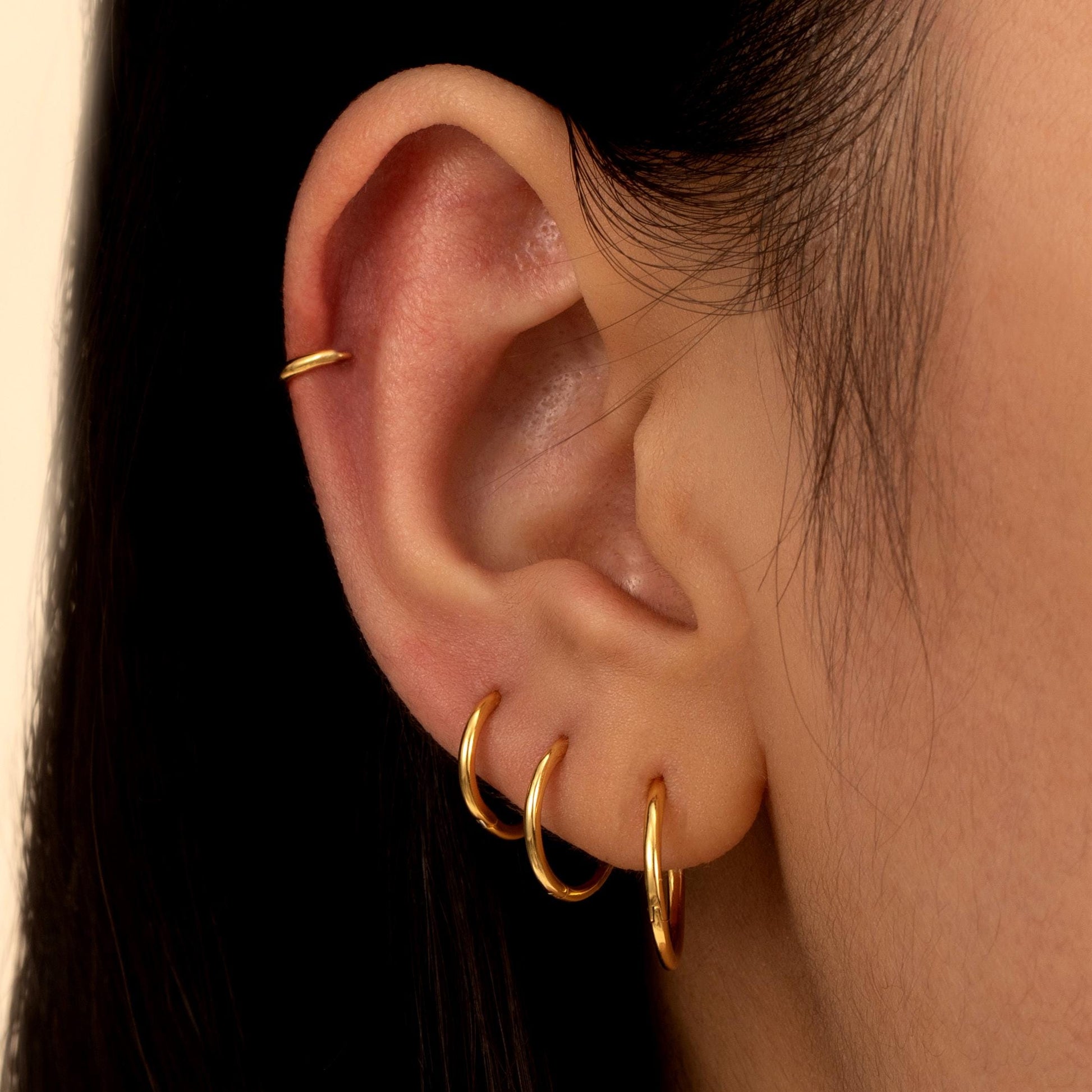 a close up of a person wearing a pair of earrings